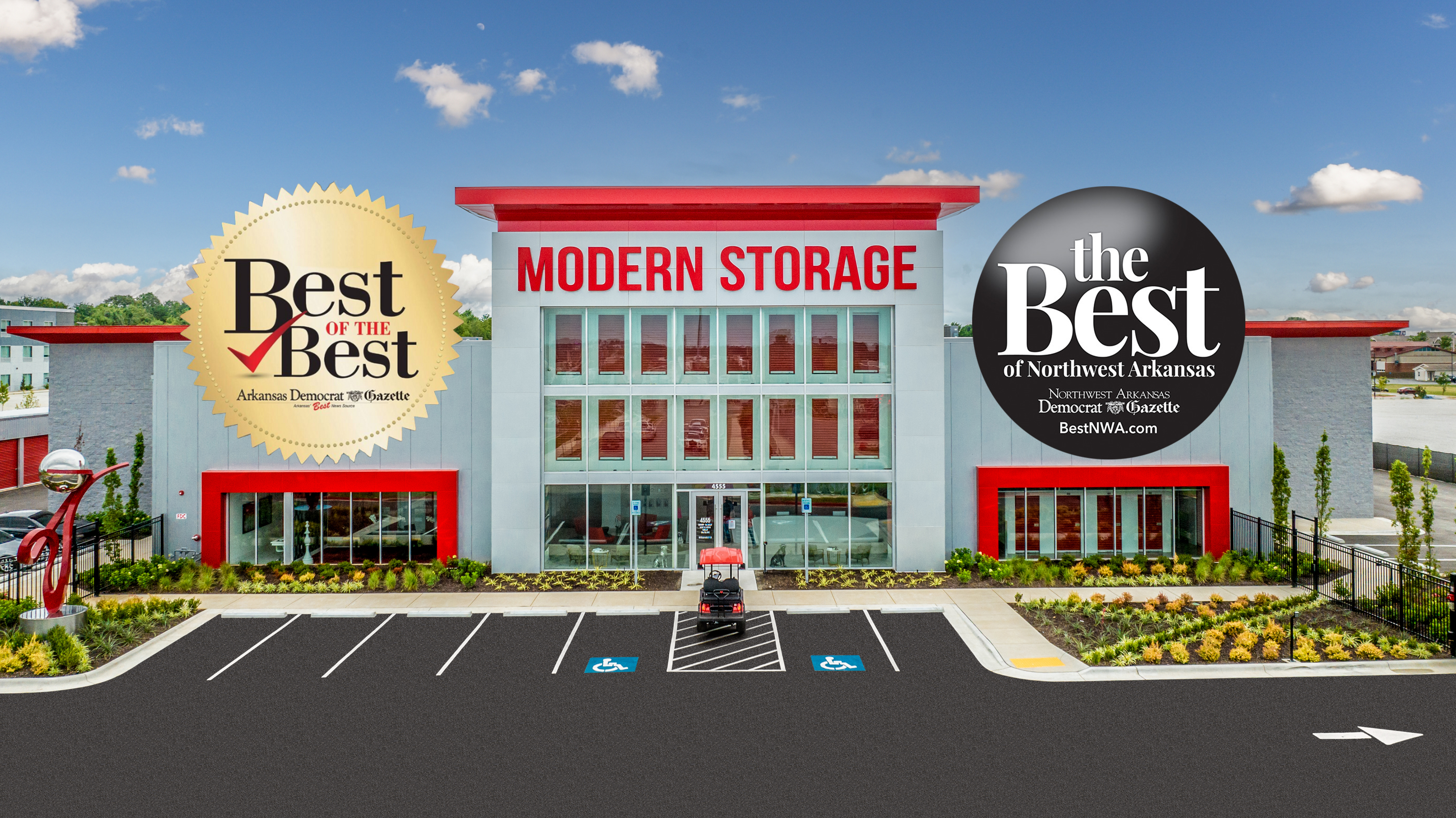 Exterior of Modern Storage® facility with Best of the Best award banners and sleek red-and-white architecture